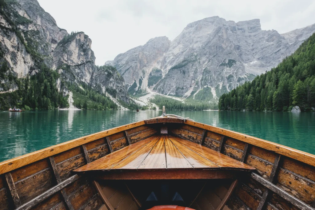 Wooden boat in water with mountains